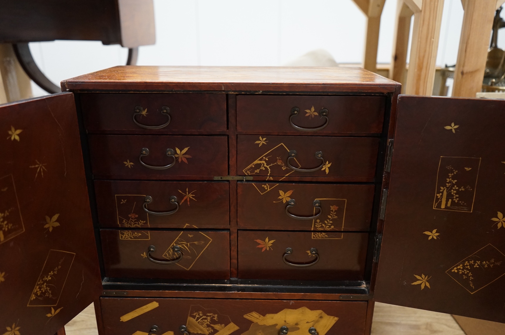 A Japanese lacquered table cabinet and shelves, largest 53.5 x 45cm